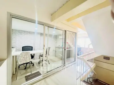 Modern office space with glass partition and stylish furniture