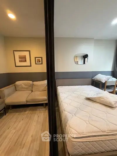 Modern bedroom with cozy sofa and stylish decor in a contemporary apartment.
