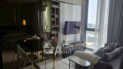 Modern living room with city view, sleek furniture, and stylish decor in a high-rise apartment.