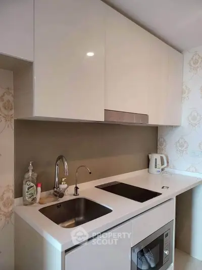 Modern kitchen with sleek cabinets and built-in appliances