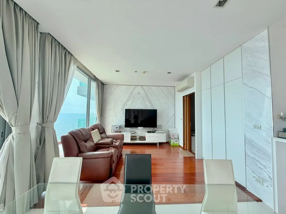 Luxurious modern living room with marble accents and large windows