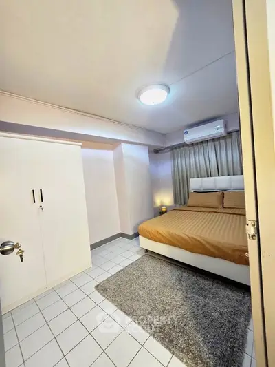 Cozy bedroom with modern furnishings and air conditioning in a stylish apartment.