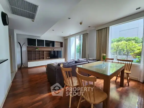 Spacious living room with modern furniture and large windows offering natural light.