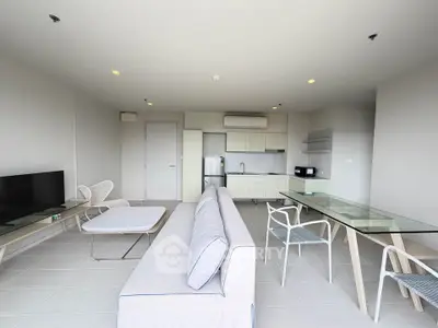 Spacious modern living room with open kitchen and stylish furniture