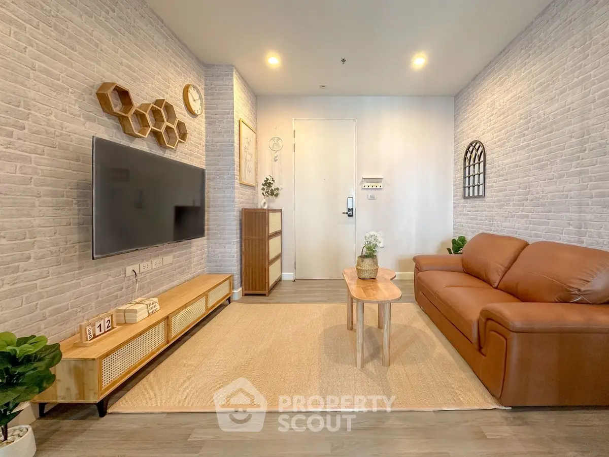 Stylish living room with modern decor, leather sofa, and wall-mounted TV in a cozy apartment.