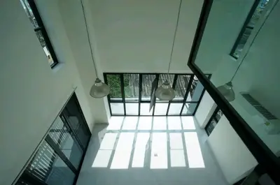 Spacious modern living room with high ceilings and large windows for natural light.