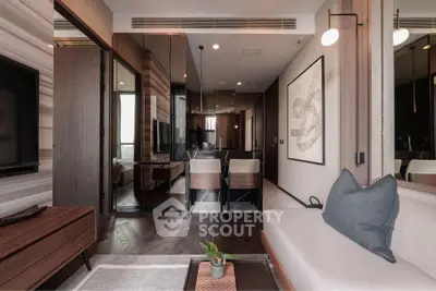 Modern living room with sleek design and elegant decor, featuring a cozy seating area and stylish dining space.