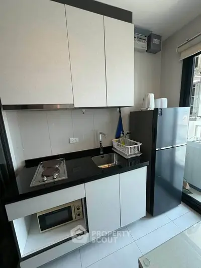 Modern compact kitchen with sleek cabinetry and appliances