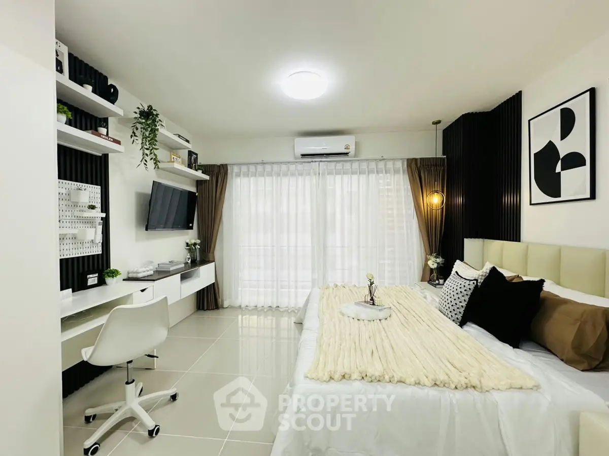 Modern bedroom with sleek design, featuring a cozy bed, stylish decor, and a functional workspace.