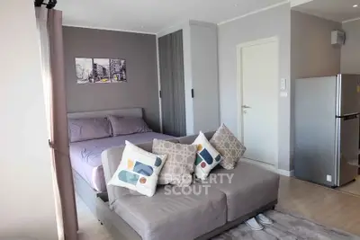 Modern studio apartment with cozy bed and stylish decor