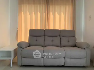Cozy living room with plush gray sofa and soft lighting