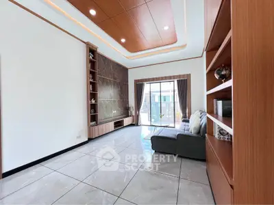 Spacious modern living room with elegant wood paneling and large windows.