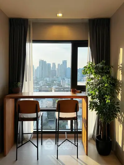 Chic urban apartment with stunning city view and cozy seating area by the window.