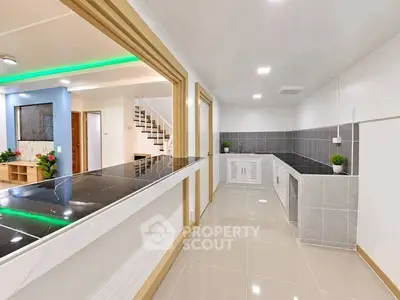 Modern open-layout kitchen with sleek countertops and stylish lighting