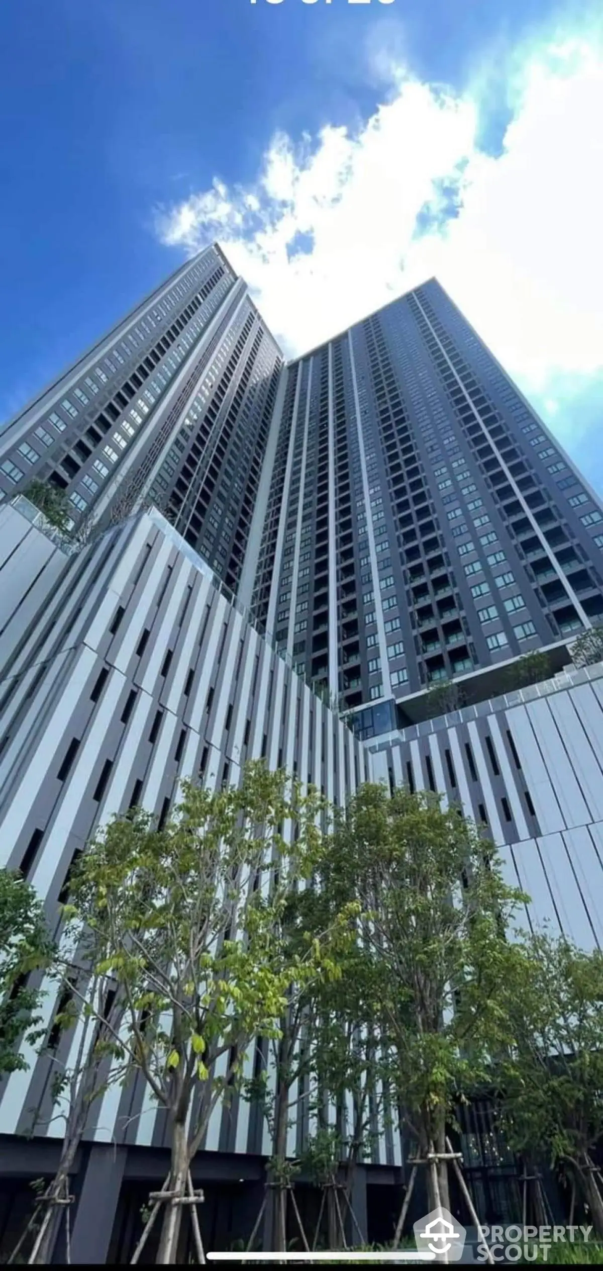 Stunning high-rise building with modern architecture and lush greenery