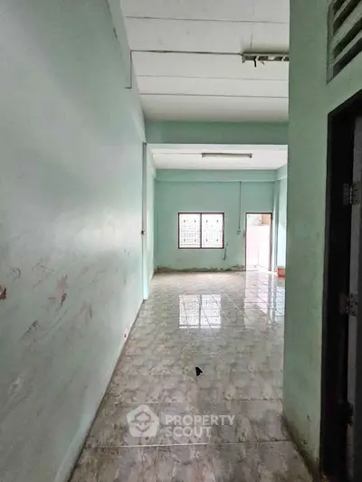 Spacious interior with tiled flooring and natural light, ideal for customization.