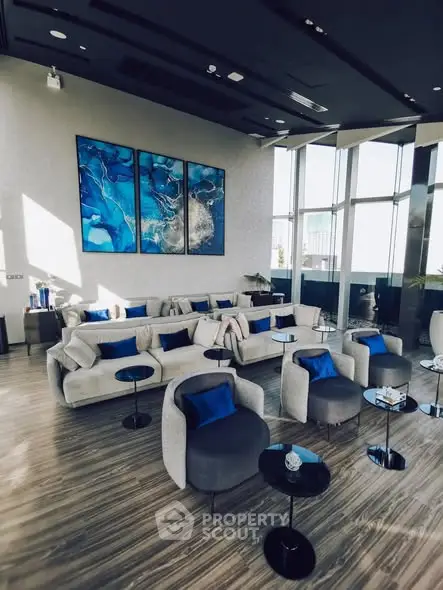 Luxurious modern living room with elegant blue accents and panoramic windows.