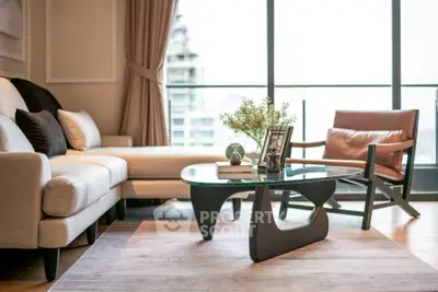 Luxurious living room with modern furniture and large windows offering a stunning city view.