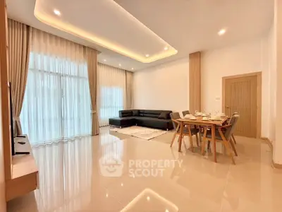 Spacious modern living room with elegant lighting and large windows