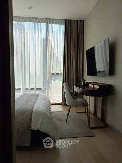 Modern bedroom with large window, sleek furniture, and wall-mounted TV, perfect for urban living.