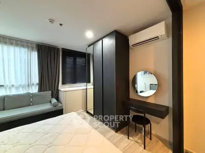 Modern bedroom with stylish decor, featuring a cozy bed, built-in wardrobe, and a sleek vanity area.
