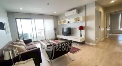 Modern living room with sleek furniture and large windows offering natural light.