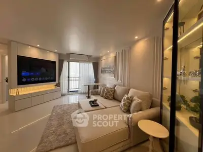 Luxurious living room with modern decor, large TV, and elegant furniture in a bright, spacious apartment.