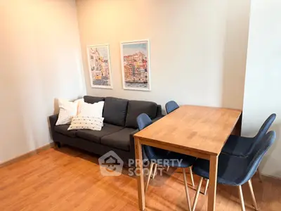 Cozy living room with modern sofa and dining table, perfect for urban living.