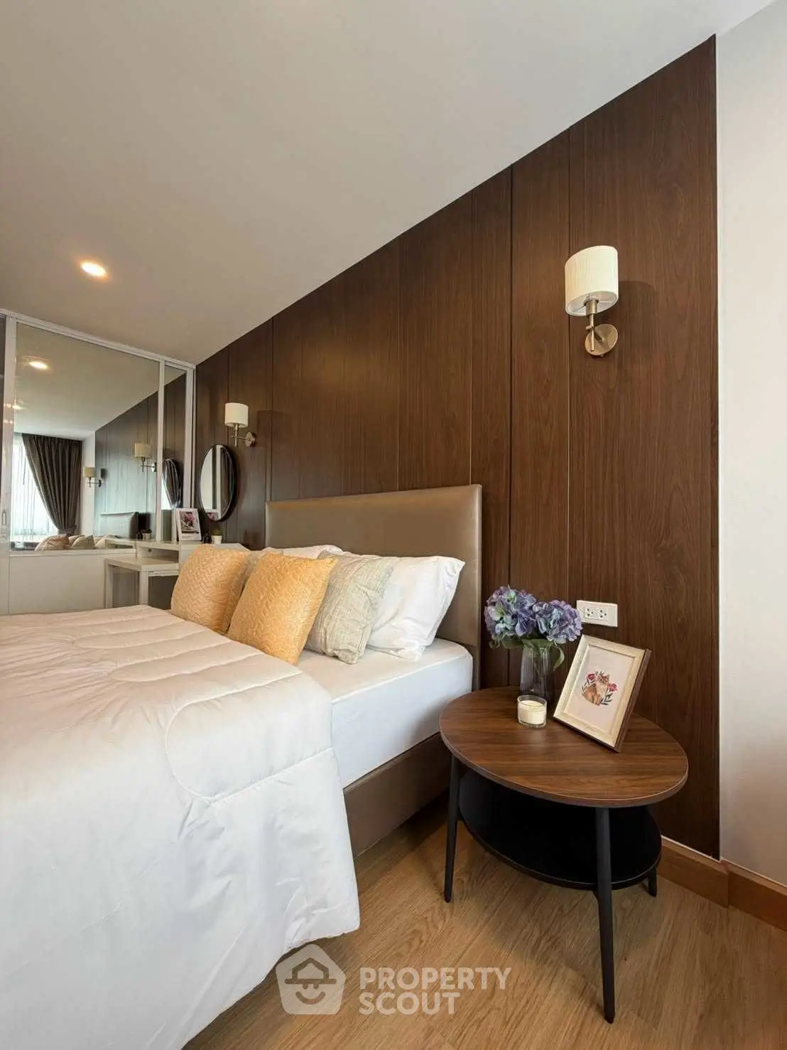 Elegant bedroom with modern decor, featuring a cozy bed, stylish wooden wall, and soft lighting for a relaxing ambiance.