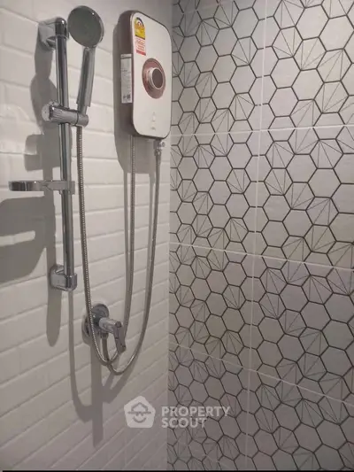 Modern bathroom shower with geometric tile design and sleek fixtures