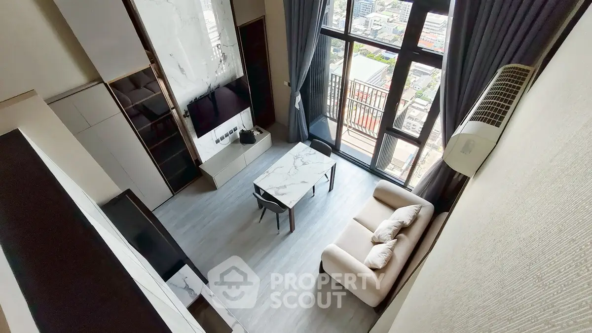Modern high-rise apartment living room with floor-to-ceiling windows and city view.