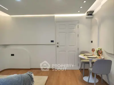 Modern minimalist living room with cozy dining area and stylish decor