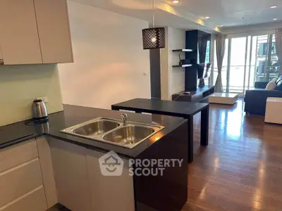Modern open-plan kitchen and living room with sleek design and natural light.