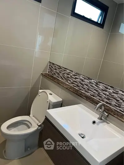Modern bathroom with sleek sink and stylish tile backsplash