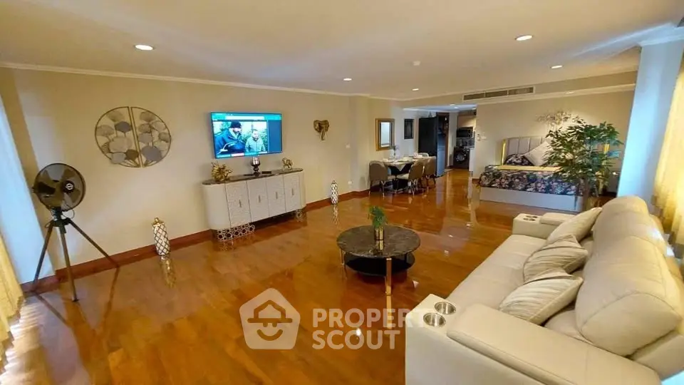 Spacious living room with elegant decor and open layout, featuring a cozy seating area and dining space.