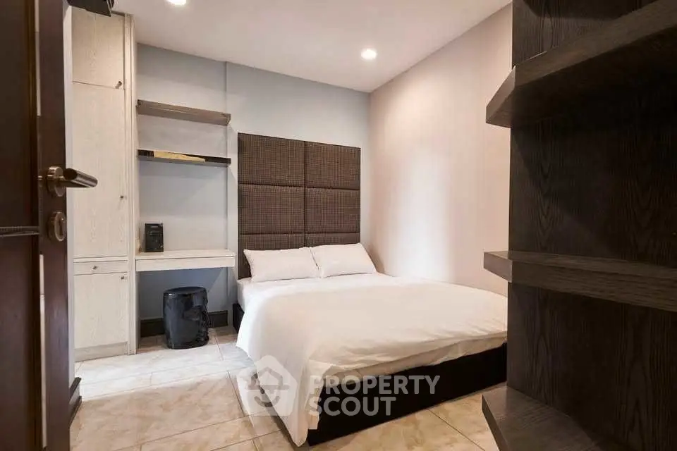 Cozy modern bedroom with stylish shelving and ambient lighting