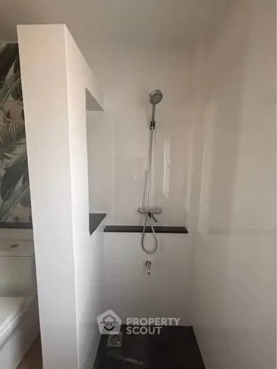 Modern bathroom with sleek shower design and tropical accent wall