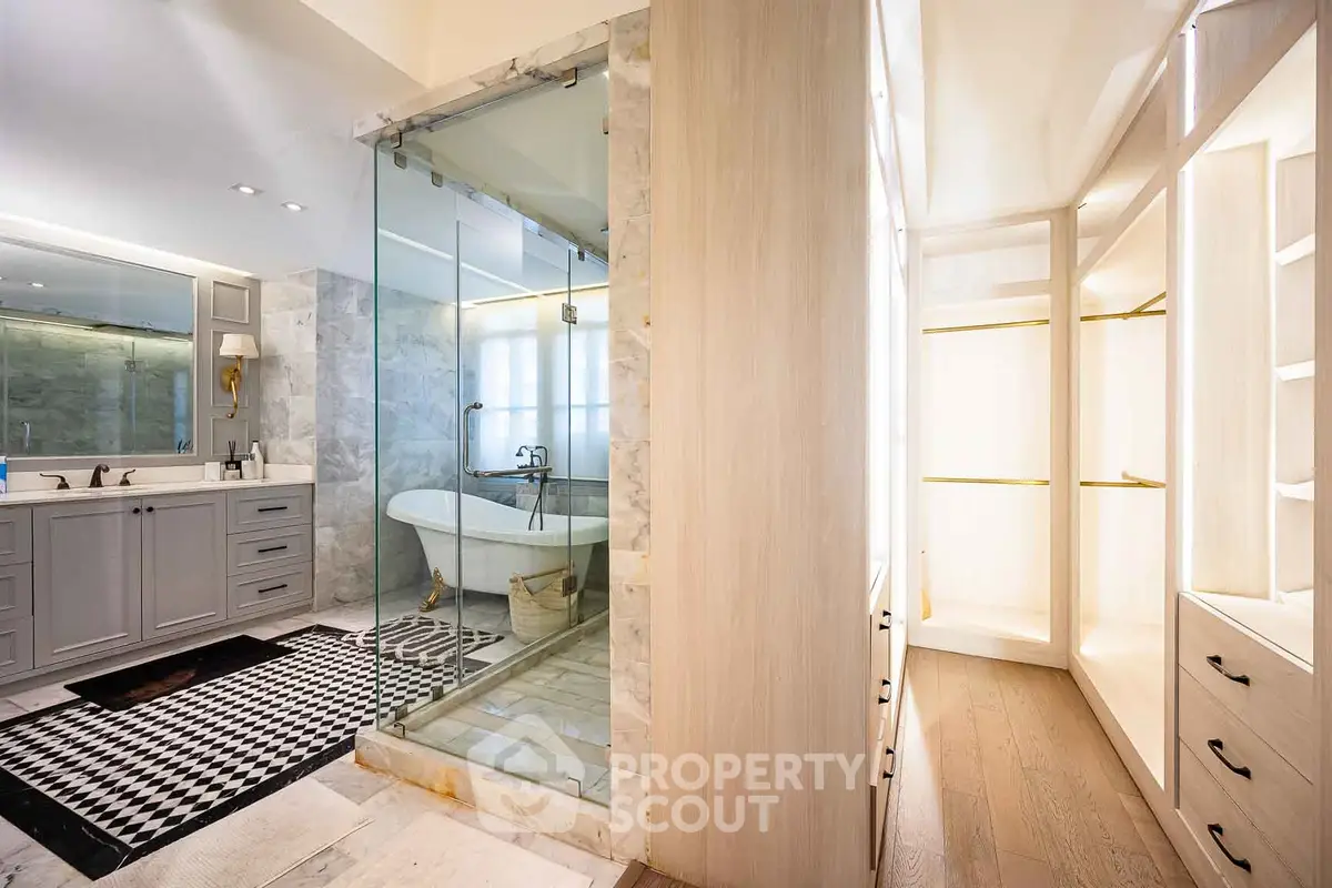 Luxurious bathroom with freestanding bathtub and elegant walk-in closet
