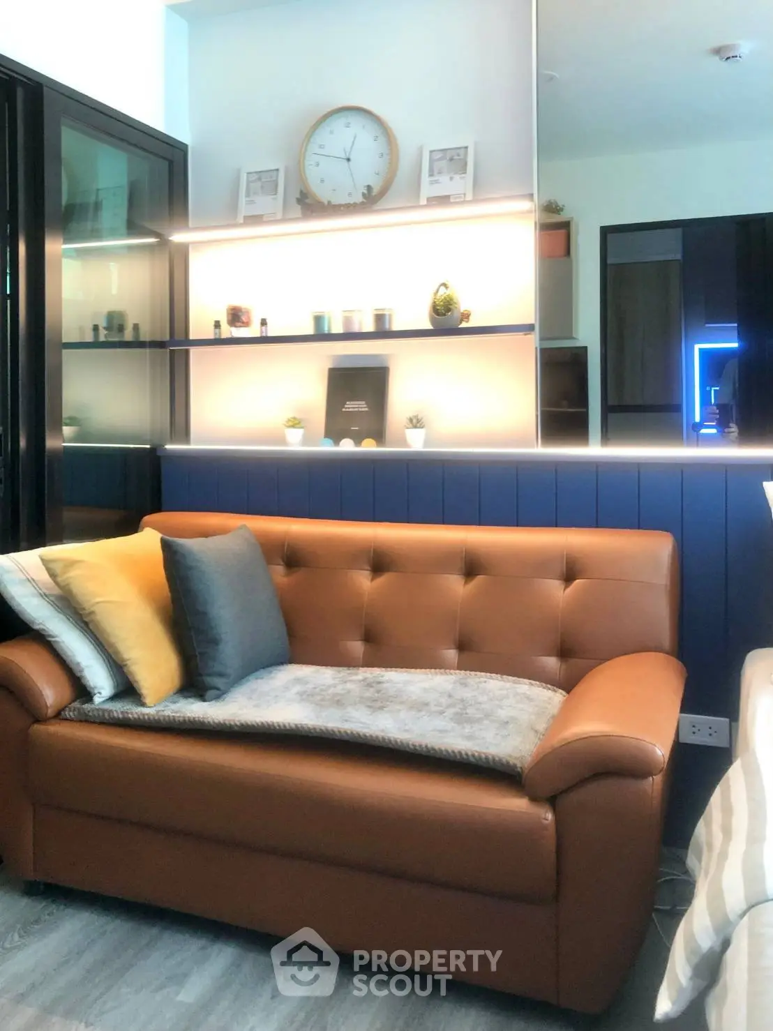 Stylish living room with modern leather sofa and decorative shelving