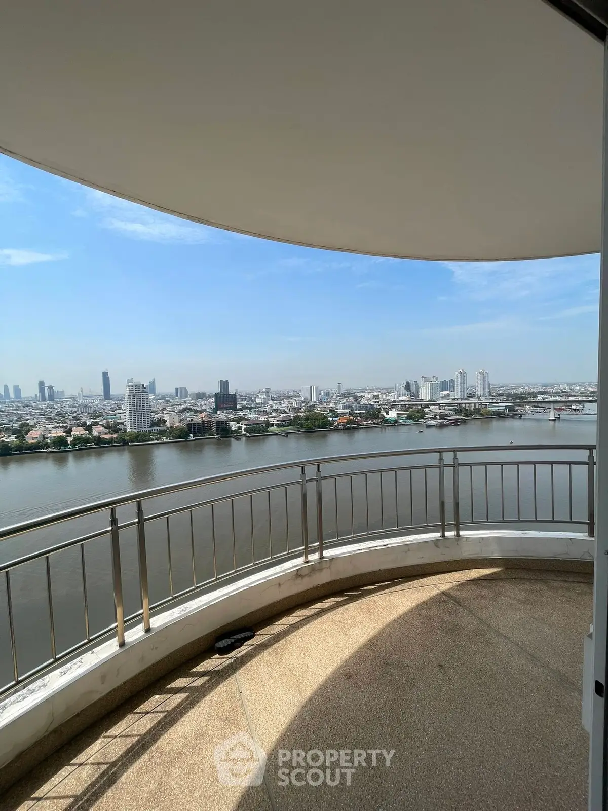 Stunning river view from a spacious balcony in a high-rise apartment.