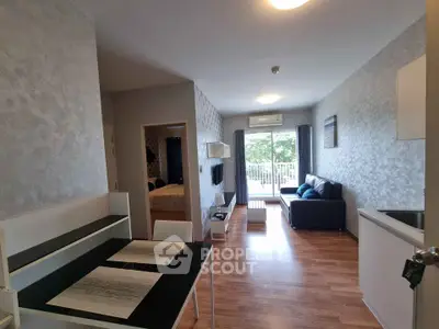 Modern open-plan living room with sleek furniture and balcony view