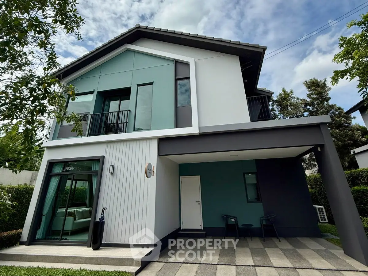 Modern two-story house with sleek design and lush greenery, perfect for contemporary living.