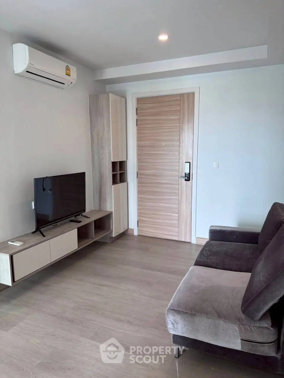 Modern living room with sleek furniture and air conditioning, perfect for comfort and relaxation.