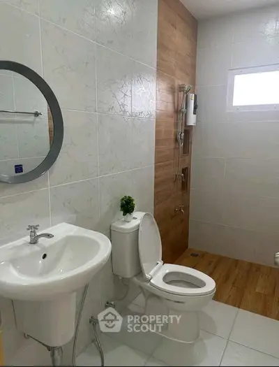 Modern bathroom with sleek fixtures and wood accent wall