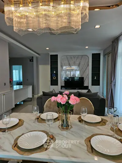 Luxurious dining area with elegant chandelier and marble table setting