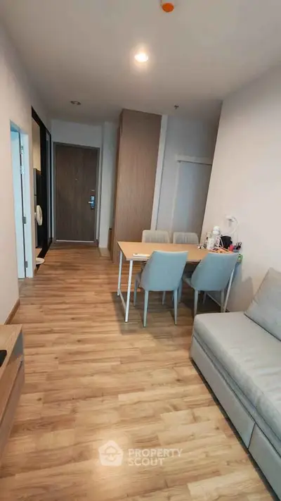 Modern apartment interior with wooden flooring and cozy dining area.