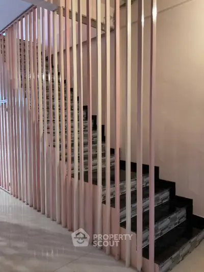 Modern staircase with sleek vertical railings in a contemporary home interior