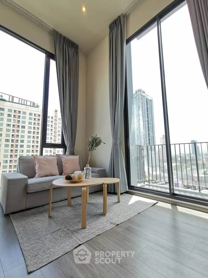 Bright and airy living room with floor-to-ceiling windows and city view.
