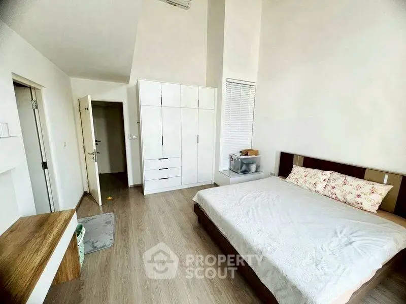 Spacious bedroom with modern design and ample natural light