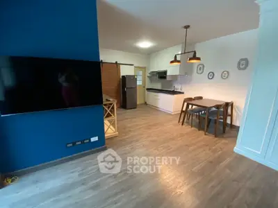 Modern open-plan living room with stylish kitchen and dining area